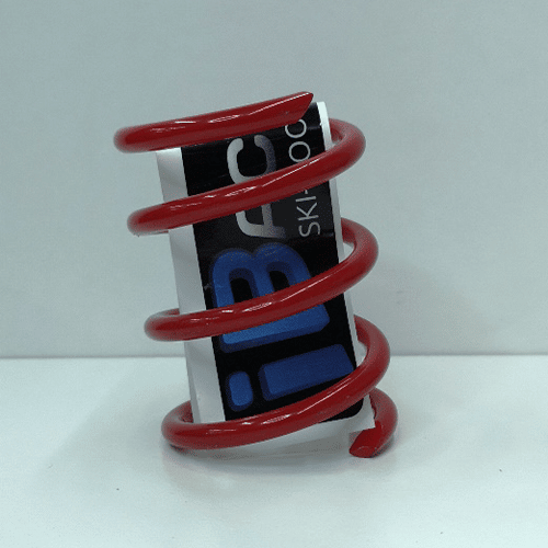 A red spiral spring holder on a white surface featuring a Ski-Doo Secondary Clutch Spring Red [210/310].