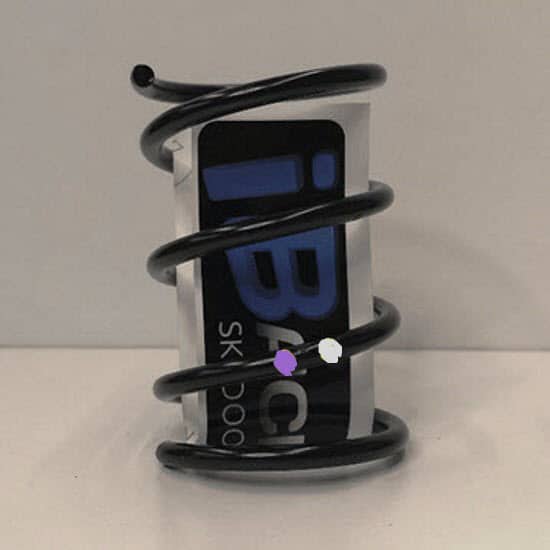 A black spiral bottle holder with a purple label on it for the Ski-Doo pDrive Clutch Spring Purple/Silver [120/370].
